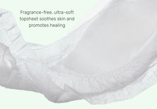 Close-up of a white diaper with text highlighting its benefits.
